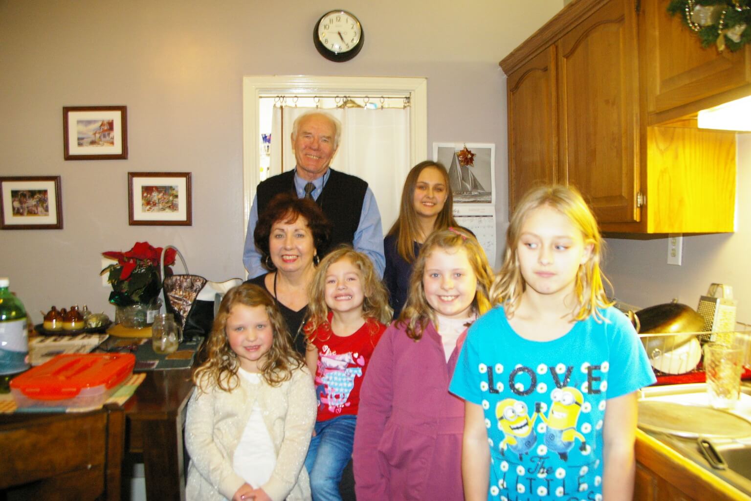 A family posing for a picture in the kitchen.