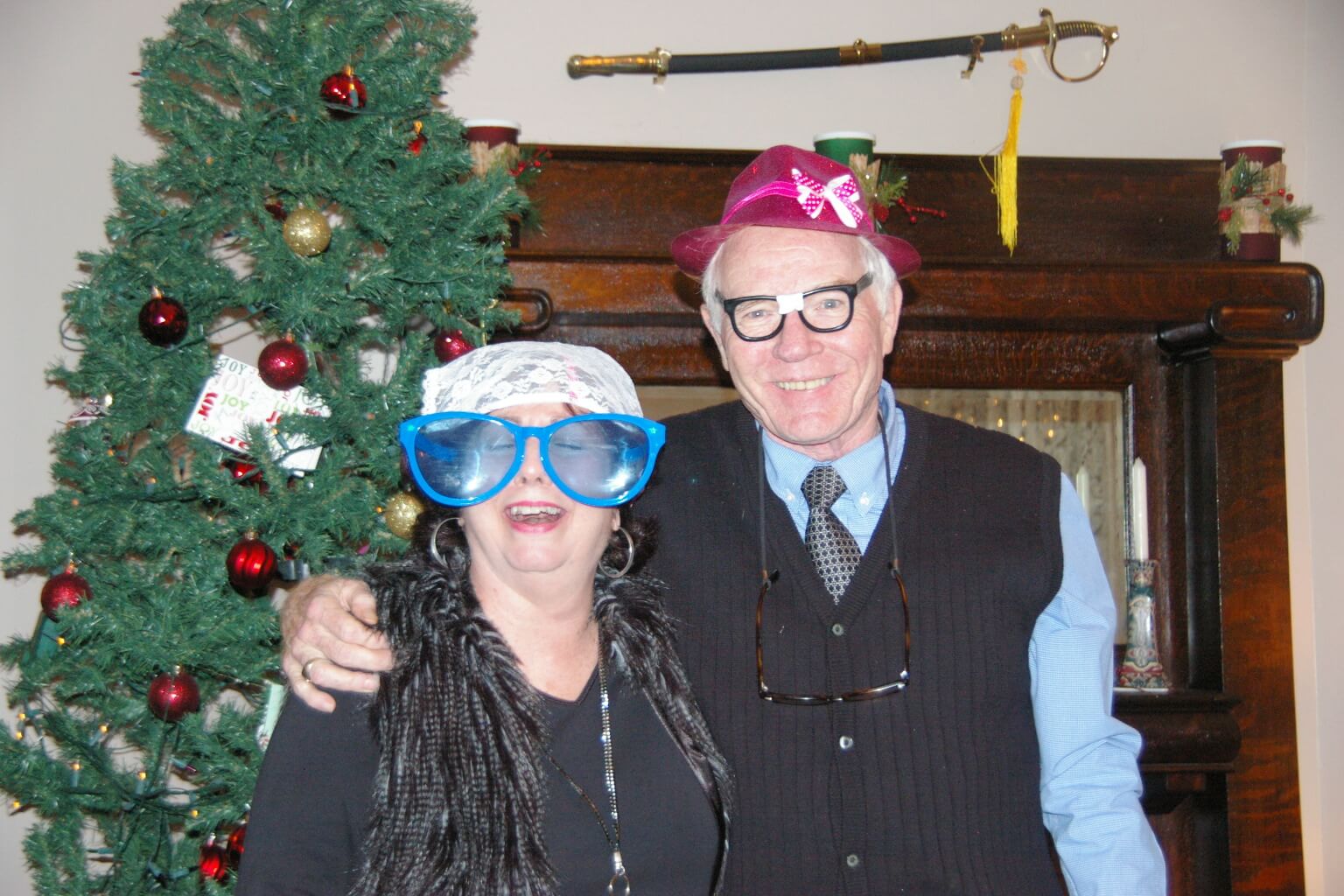 A man and woman wearing funny glasses posing for the camera.